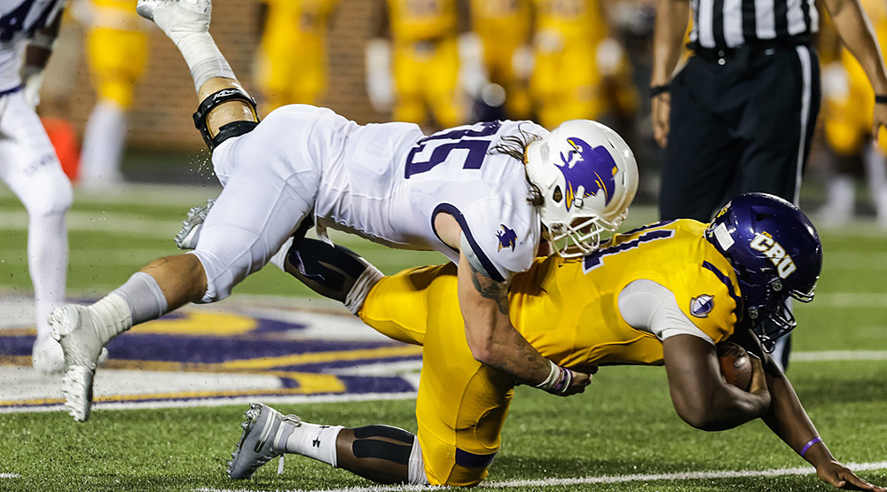 Hardin-Simmons tackler on Mary Hardin-Baylor ball-carrier. (Hardin-Simmons athletics photo)