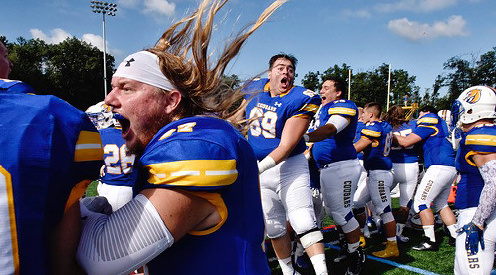 Misericordia players go crazy on the sidelines celebrating the win vs. Widener. (Misericordia athletics photo by Sean McKeag)