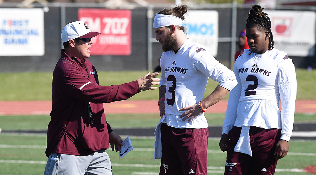 Jordan Neal with his McMurry players in practice jerseys